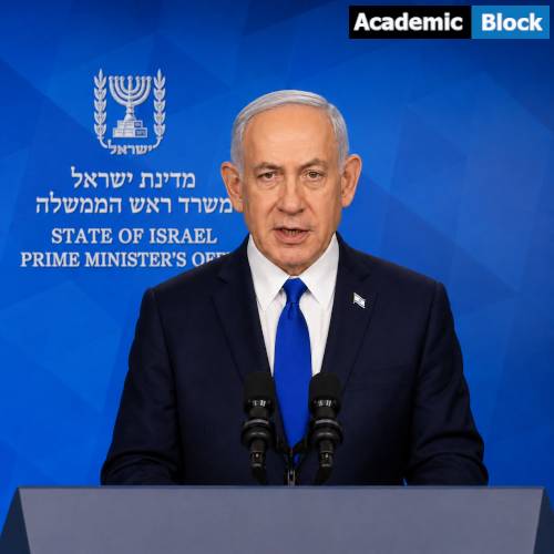 Netanyahu delivers a formal address from a podium, standing before a blue backdrop displaying the State of Israel Prime Minister’s Office emblem and text.