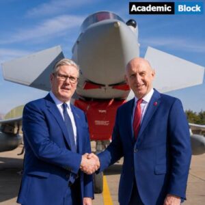 Keir Starmerand and Defence Secretary John Healey standing in front of a UK Typhoon fighter jet and shaking hands during a defence and security visit.
