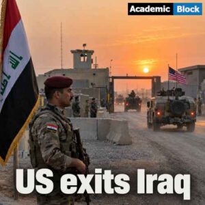An Iraqi soldier stays stationed on his post as a U.S. military convoy leaves a military compound at sunset, with the Iraqi flag, concrete barriers, and base buildings in the background.