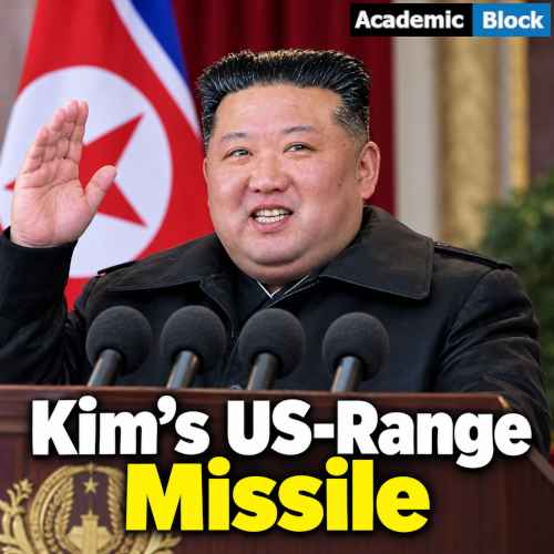 Image shows Kim Jong Un waving behind a podium with microphones and a North Korean flag in the background.